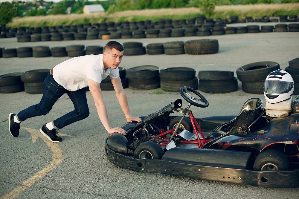 handsome man in a karting with a car